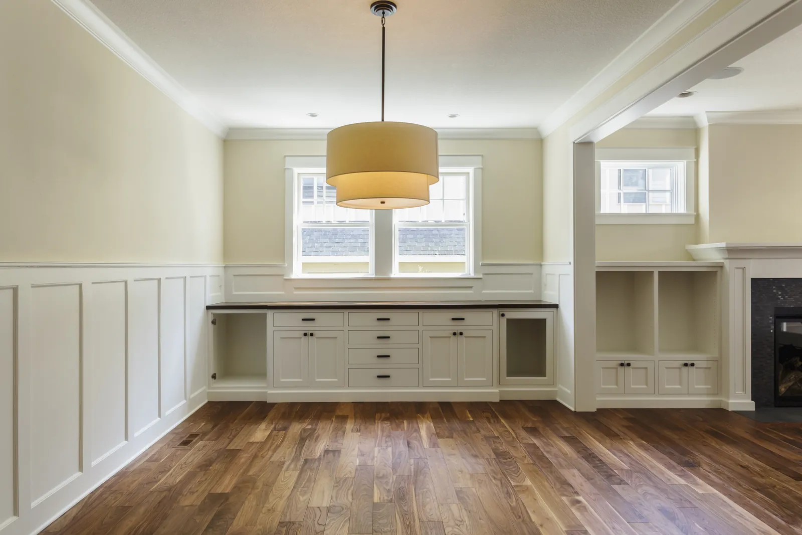 Dining room with painted built-in shelves and hardwood floors