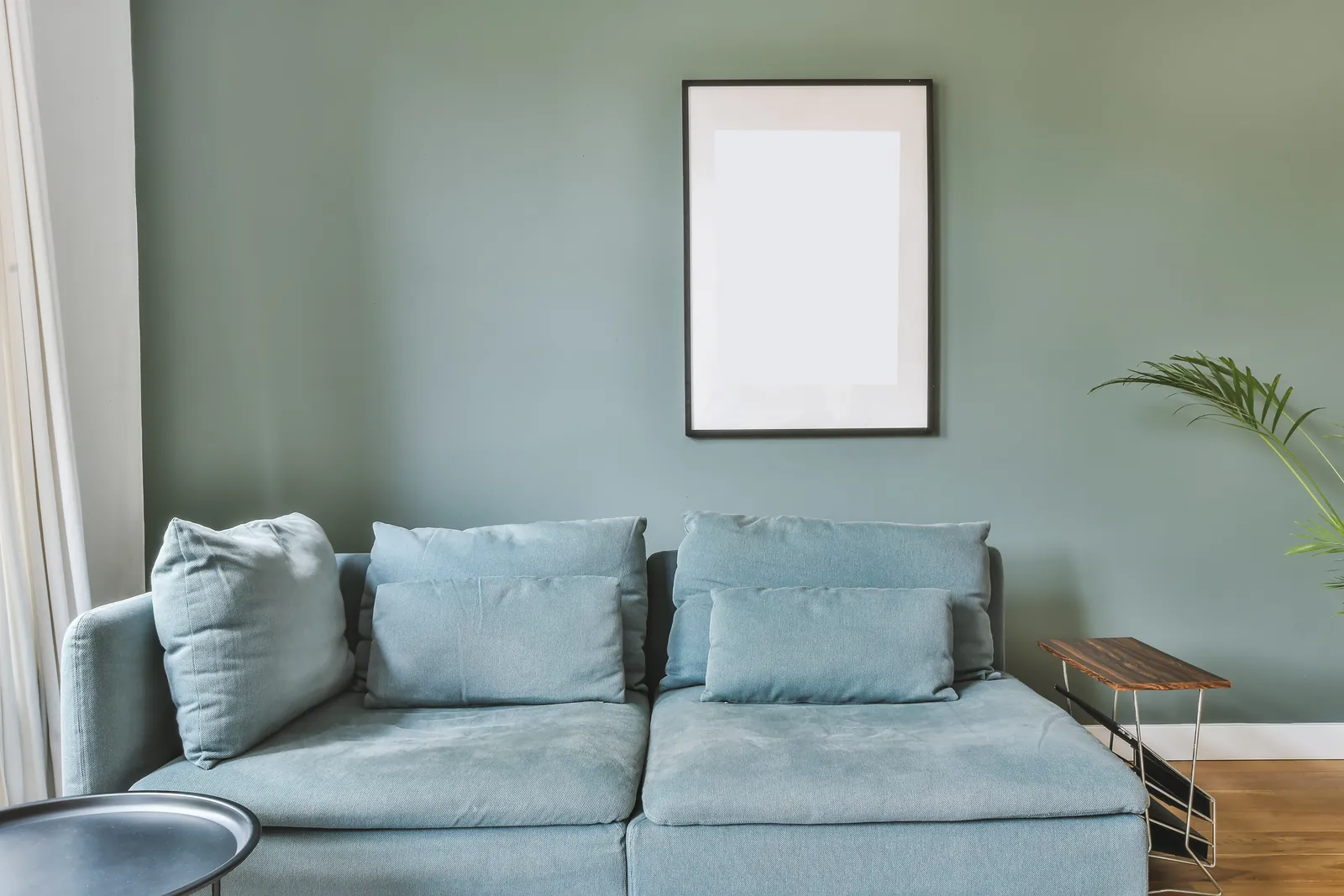 Bright living room with a sofa and freshly painted walls
