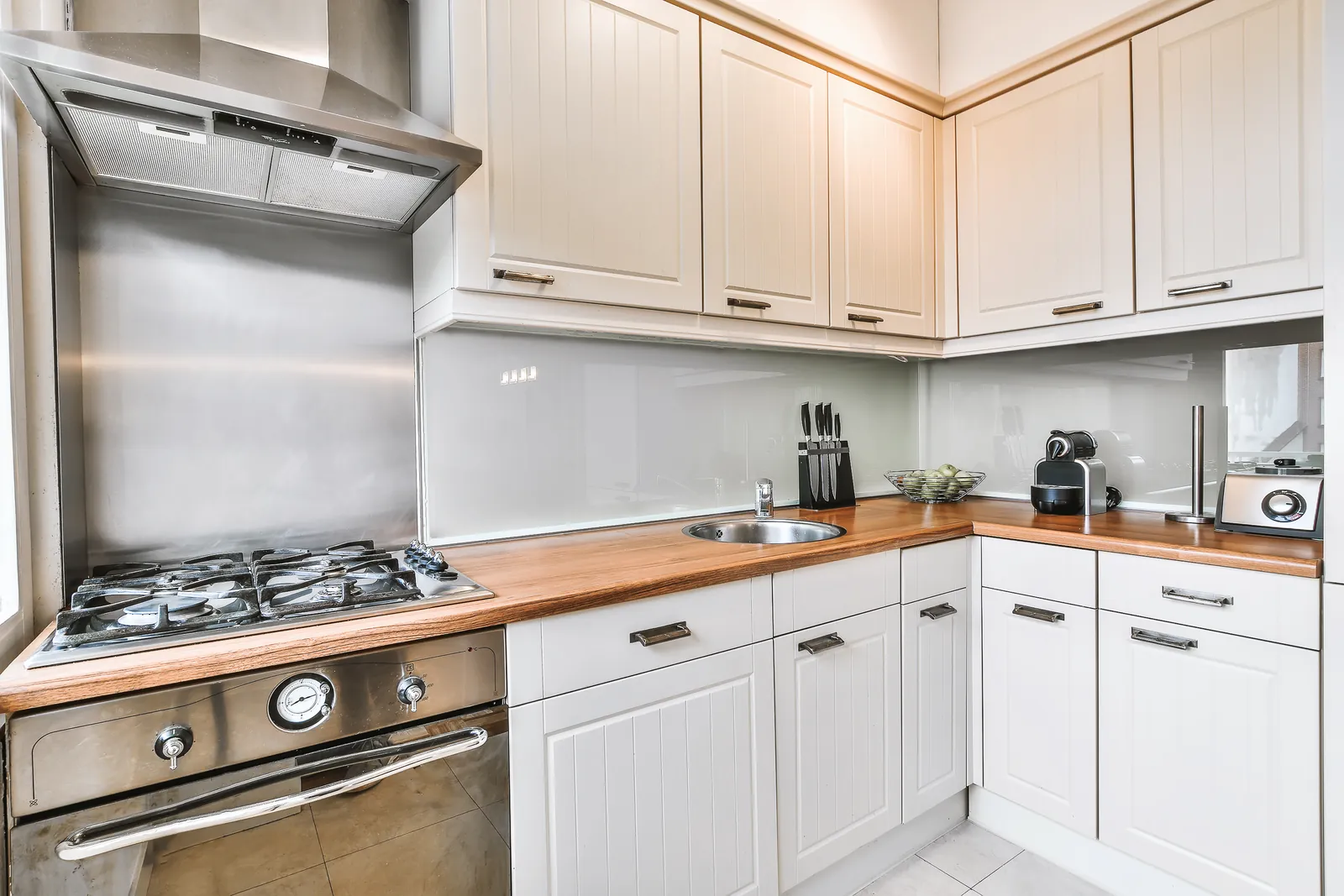 Spacious kitchen with white painted cabinets and appliances